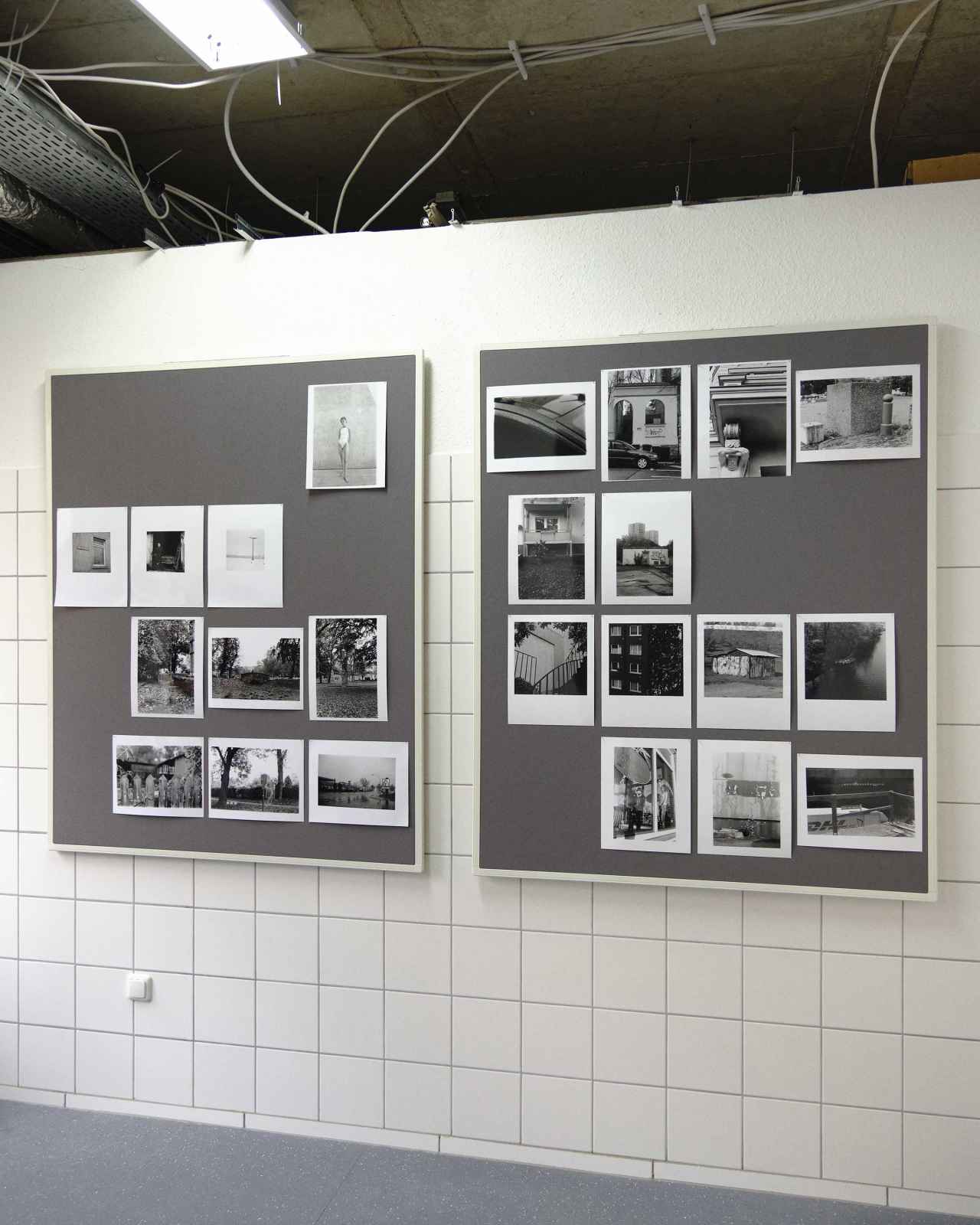 exhibition setup, two panels hung with photographs