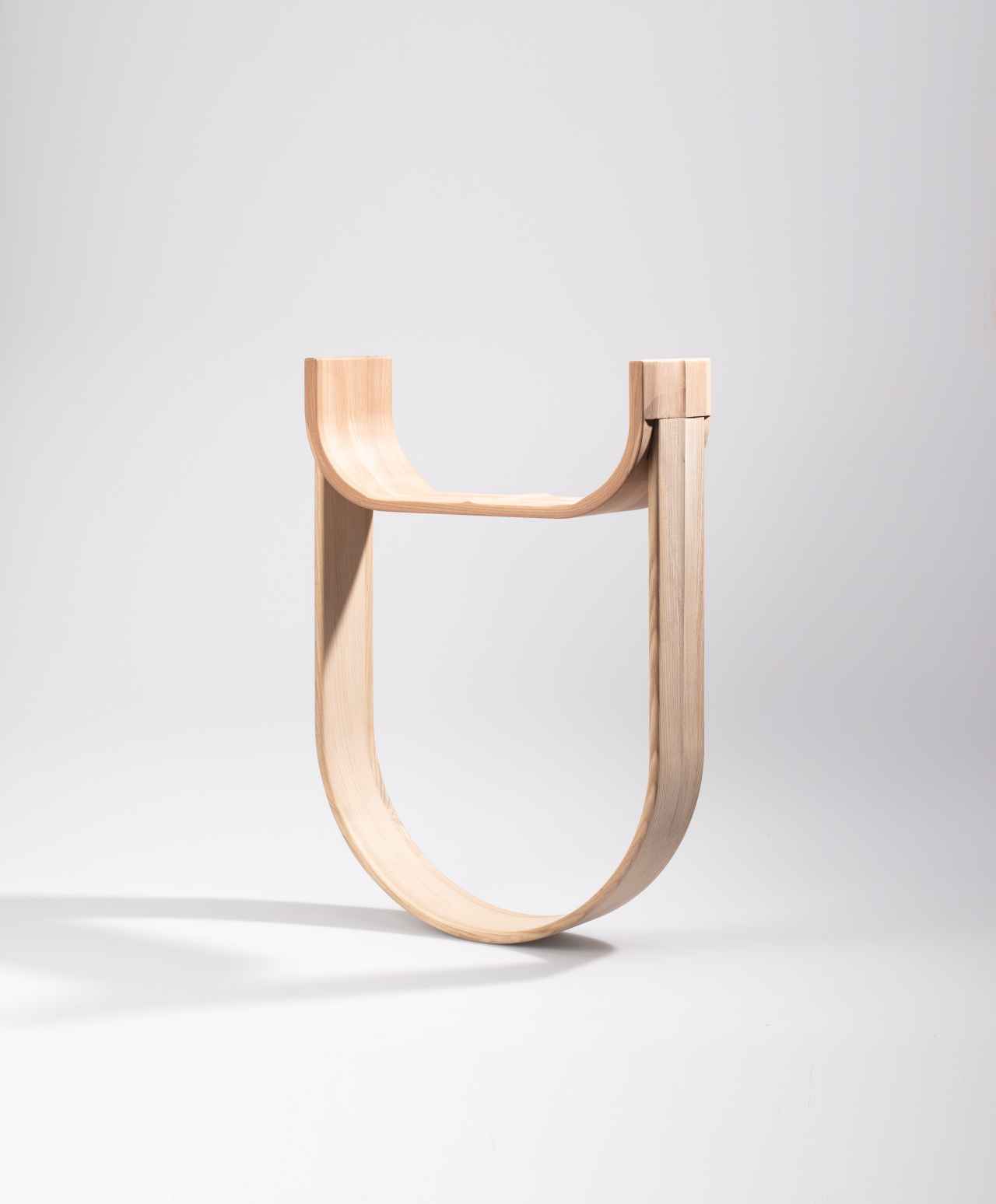 stool with lower part bent into a half-circle shape