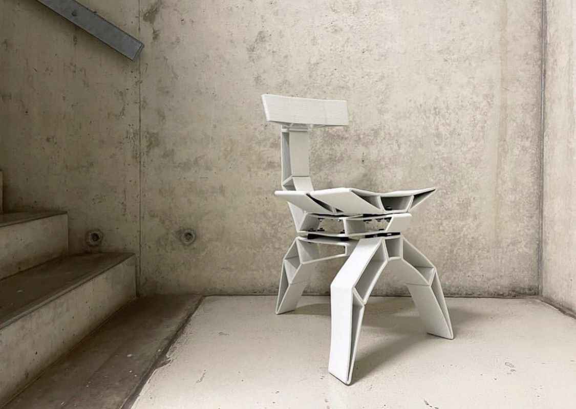 assembled ceramics chair standing in front of a concrete wall, front-view