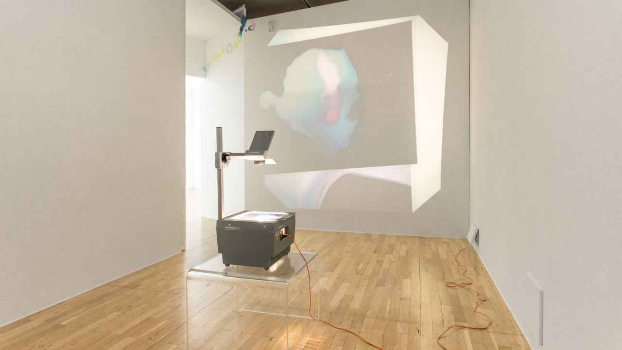 overhead projector illuminates onto wall
