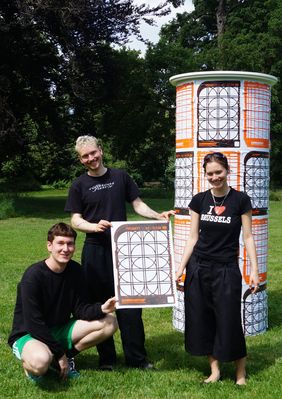 Die Studierenden Hannes Altmann, August Guccione und Ames Grund (v.l.) beim Plakatieren ihres Designs. Foto: Angye Diener