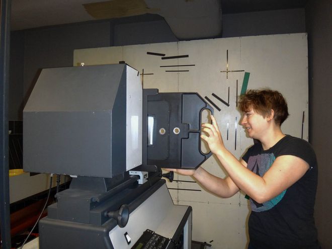 Then Anna puts the negative into the enlarger.