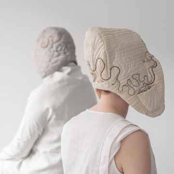 Two people wearing headgear with electrical wiring