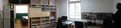 work area, with shelves, electronics storage shelves, and electronics working area (soldering iron etc)