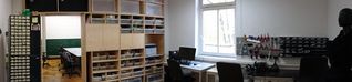 work area, with shelves, electronics storage shelves, and electronics working area (soldering iron etc)
