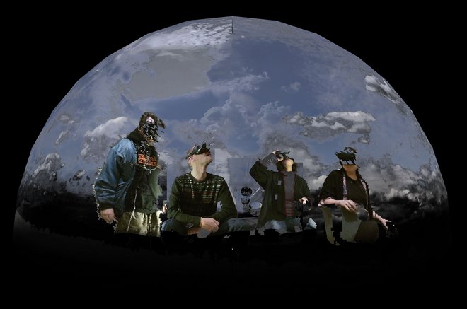 Foto dr beteiligten Künstler:innen, die unter einem gewölbten Himmel nach oben blicken. Dabei tragen sie VR-Brillen und sind verpixelt dargestellt.