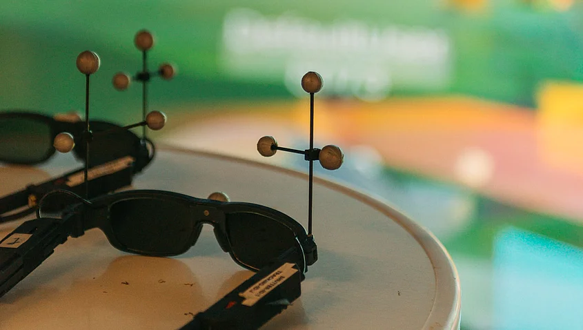VR glasses in front of a colourful screen