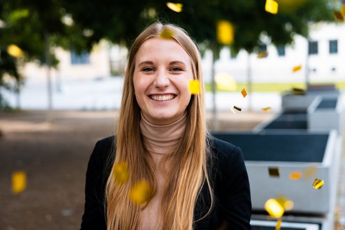Melanie Heinemann, Scientific Staff Member at the Chair of Construction Materials and herself a graduate of the class of 2021, congratulates all graduates and rains golden confetti on behalf of all graduates. (Photo: Friedrich Gerlach)