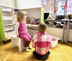 Two children playing with the contents of a KidsBox.