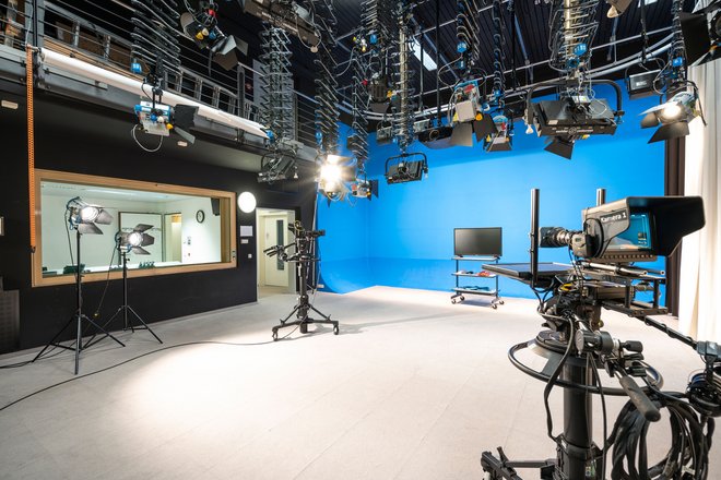 Photo of the video studio with camera and lighting equipment and bluescreen