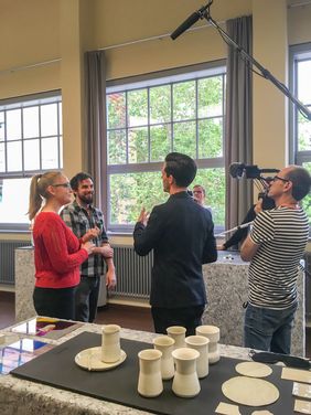 Jo Schück talking to product design graduates Filming in the Main Building
