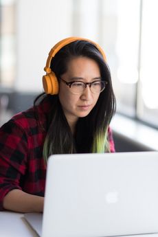 Photo of a female student working on her laptop.