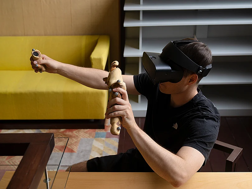 Person wearing a VR headset and holding two controllers in the reconstructed director’s office of Walter Gropius in the Main Building of the Bauhaus.