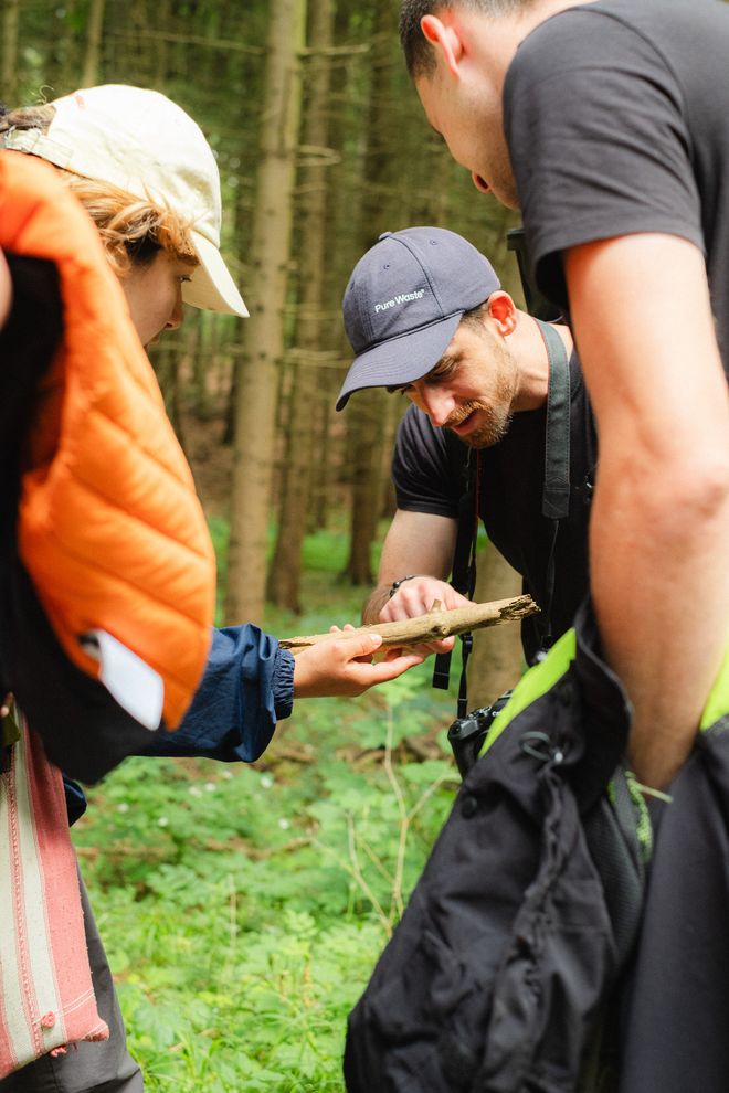 eine Gruppe schaut sich gemeinsam ein Stück Baumrinde an