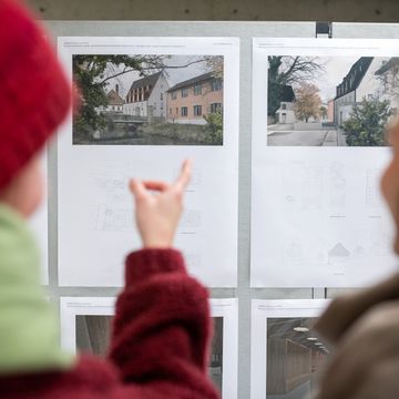 Two people look at architectural designs