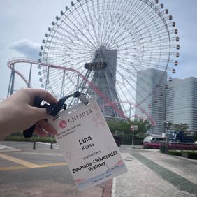 Lina Klass Conference badge in front of a ferris wheel.