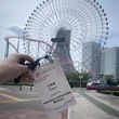 Conference badge in front of a ferris wheel.