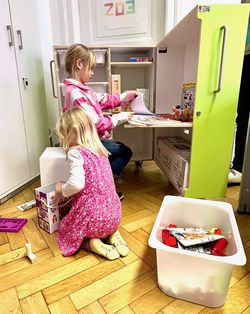 Two children playing with the contents of a KidsBox.