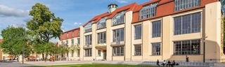 Picture of the main building of the Bauhaus-Universität Weimar. The sky is blue.