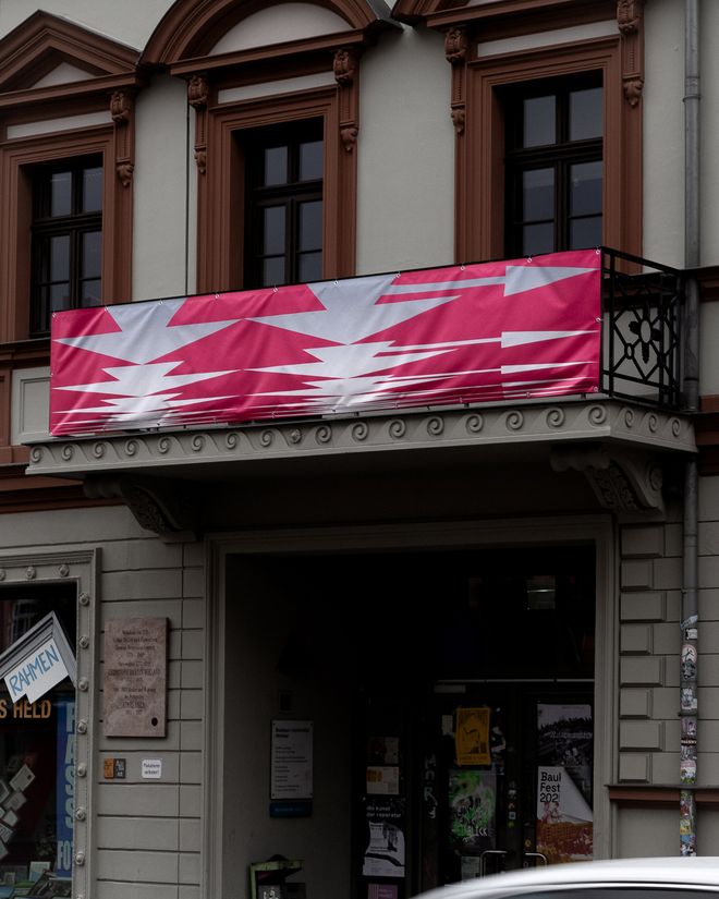 A banner on the balcony of a building