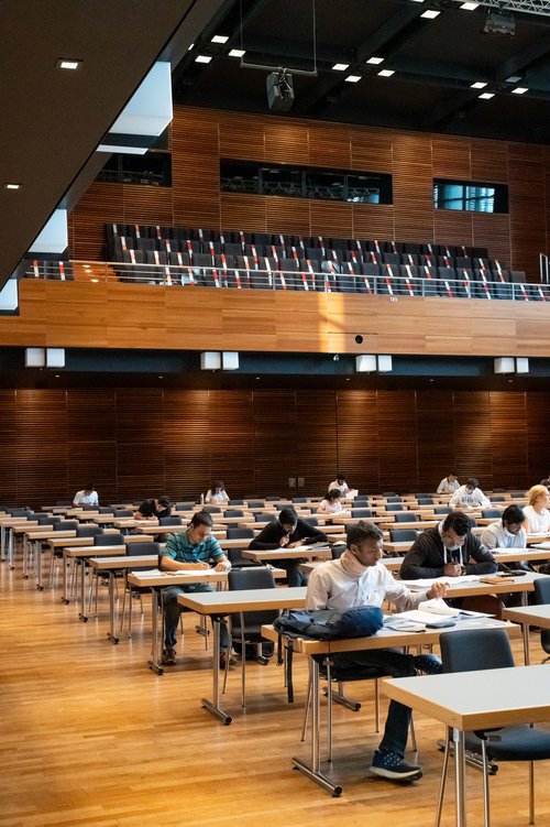 Students taking a written exam in the Weimarhalle