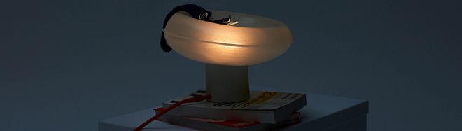 an elliptical luminaire against a dark background