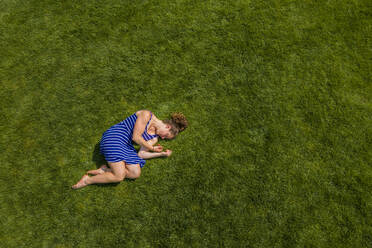 Women lying on the grass.png